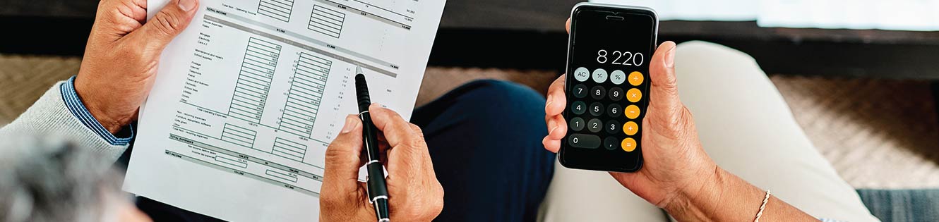 people holding a document and calculator