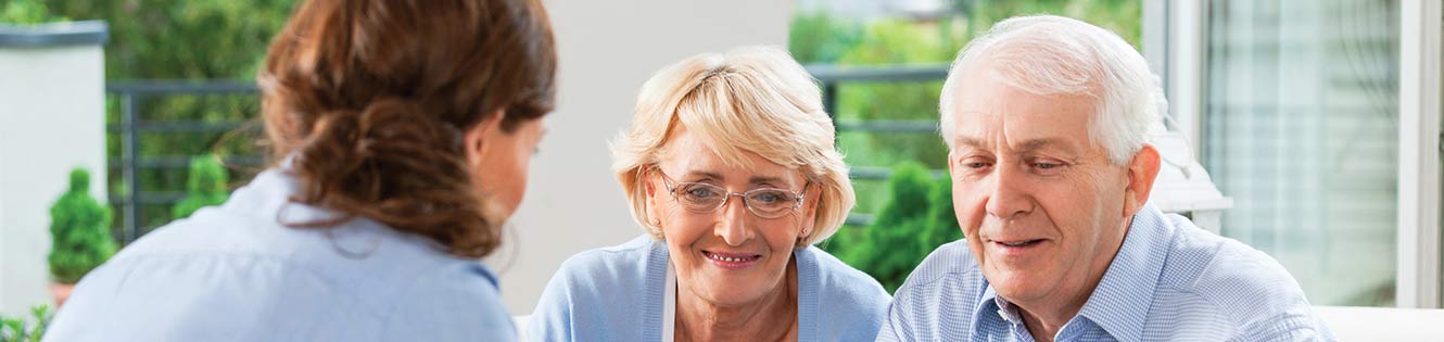 elderly couple meeting with an agent