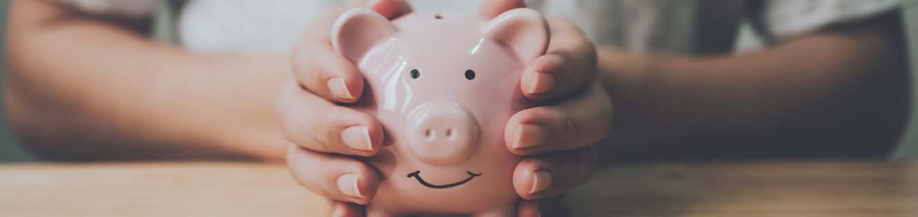 hands holding pink piggybank